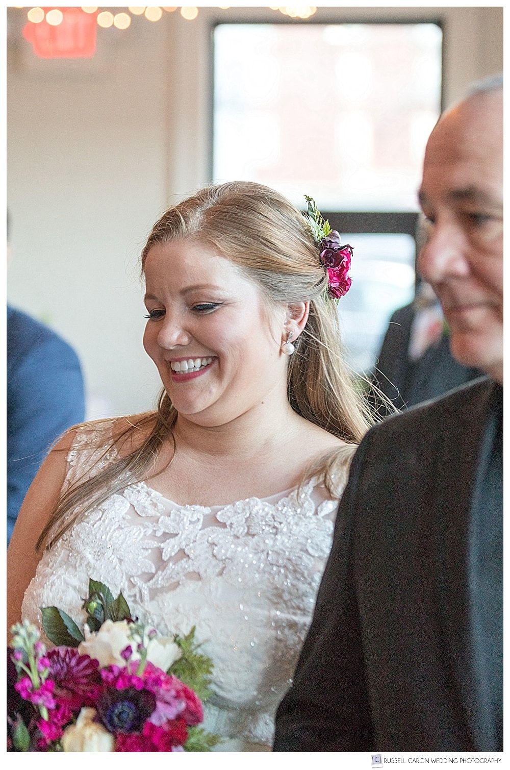 bride smiles as she approaches groom
