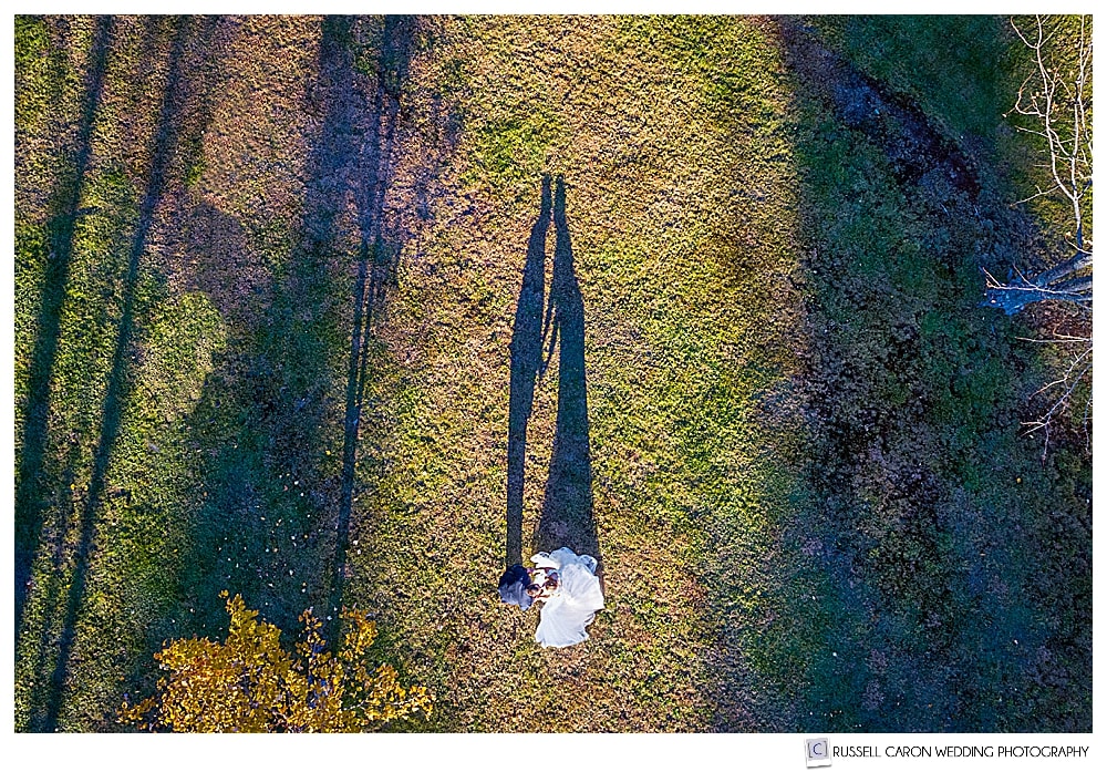 Bride and groom in southern Maine drone wedding image with shadow on the grass