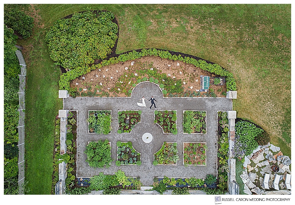 Bride and groom in unique Maine drone wedding image of a formal garden in Castine, Maine.