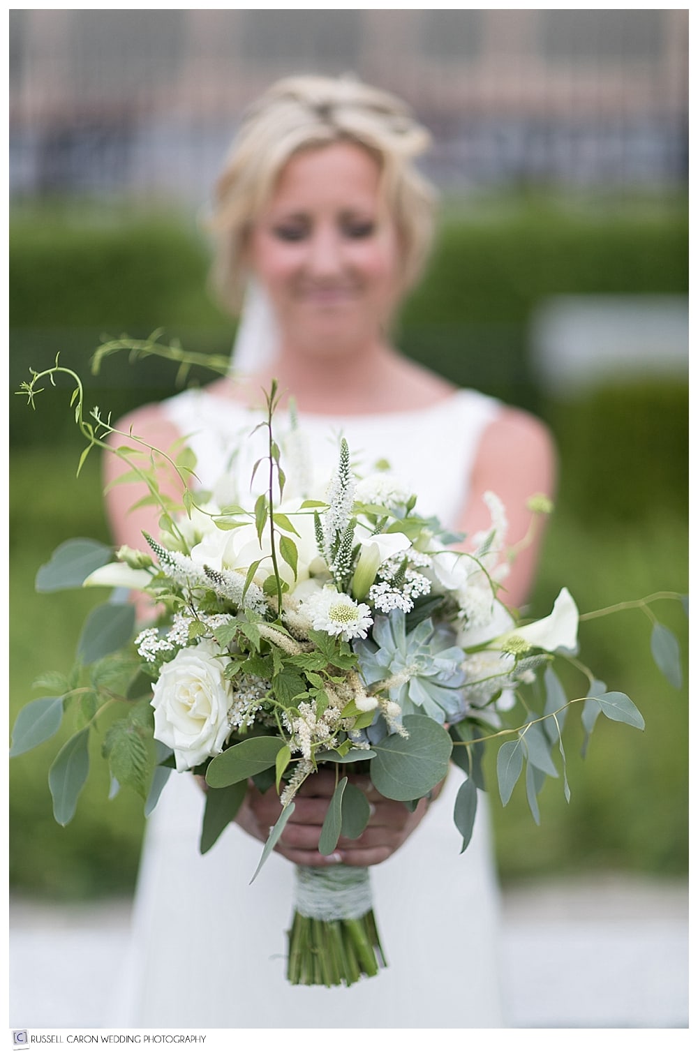 Bride holding bridal bouquet out in front