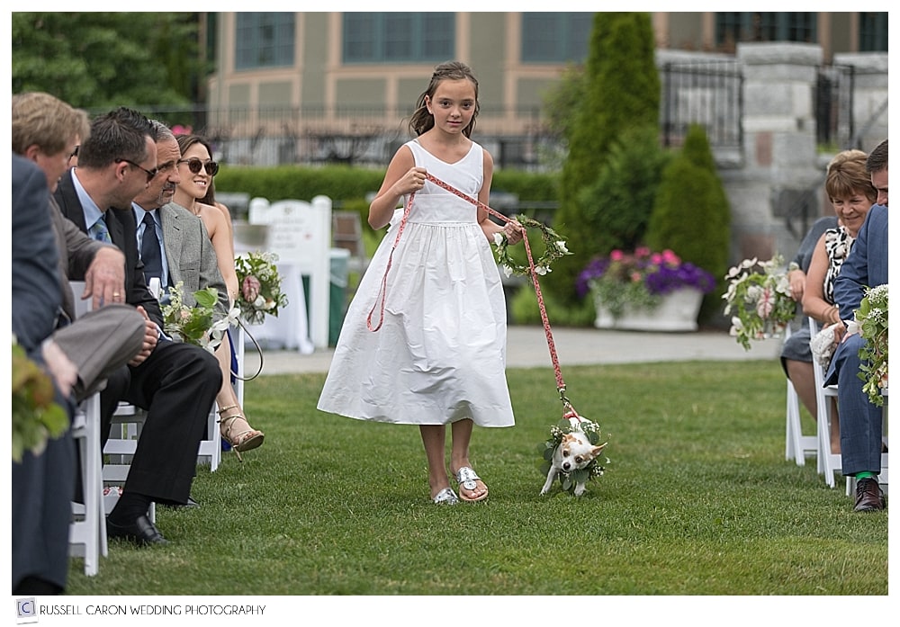 Flower girl walking down the aisle with dog