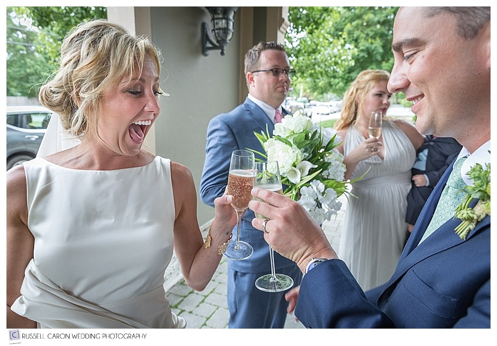 Bride and groom toast each other with champagne