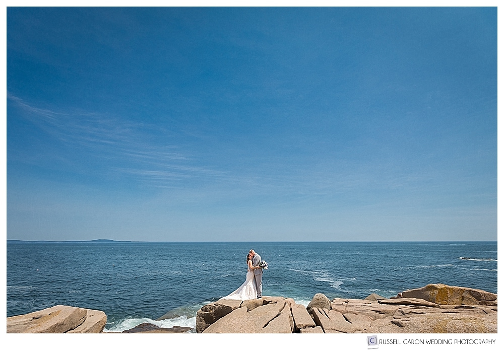 bride and groom standing on the shore of Acadia National Park, Bar Harbor, Maine. Bar Harbor Maine wedding photographers