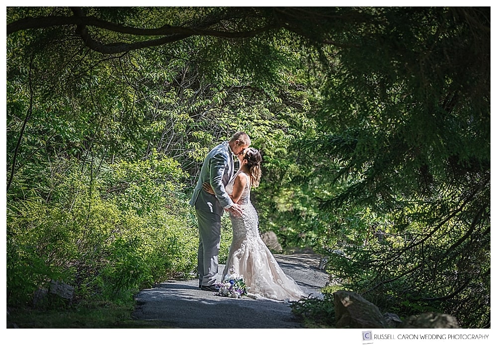 Bride and groom kissing in Acadia National Park. Bar Harbor Maine destination wedding photographers