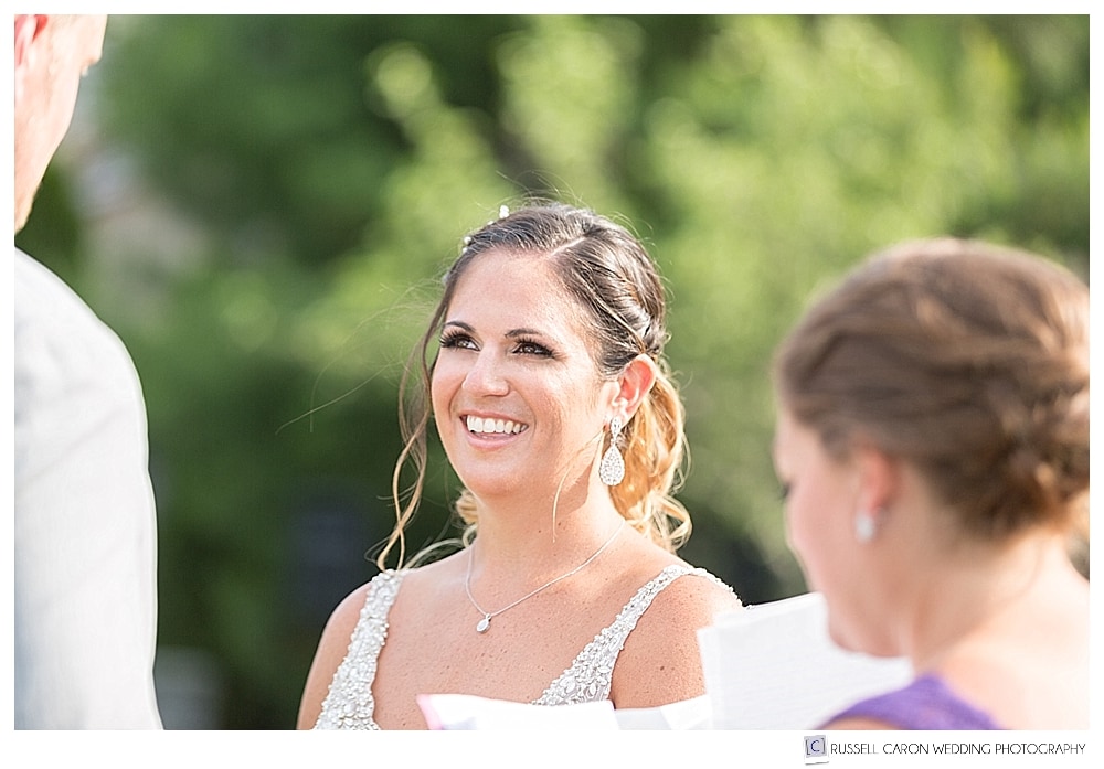 bride smiling during wedding ceremony 