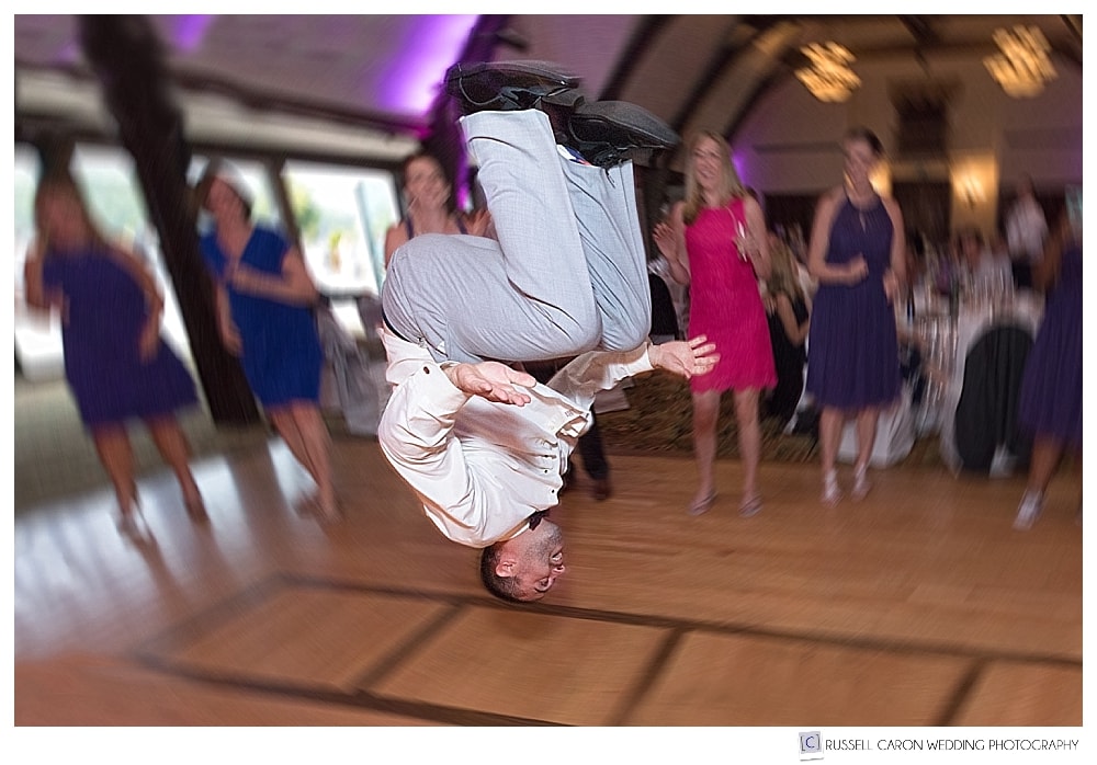 man flips during wedding reception dancing at the Bar Harbor Club, Bar Harbor, Maine.