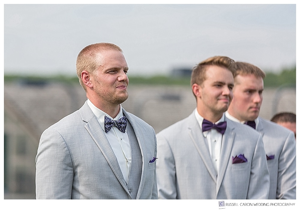 Groom watches as his bride walks down the aisle at an outdoor ceremony at the Bar Harbor Club, Bar Harbor, Maine.