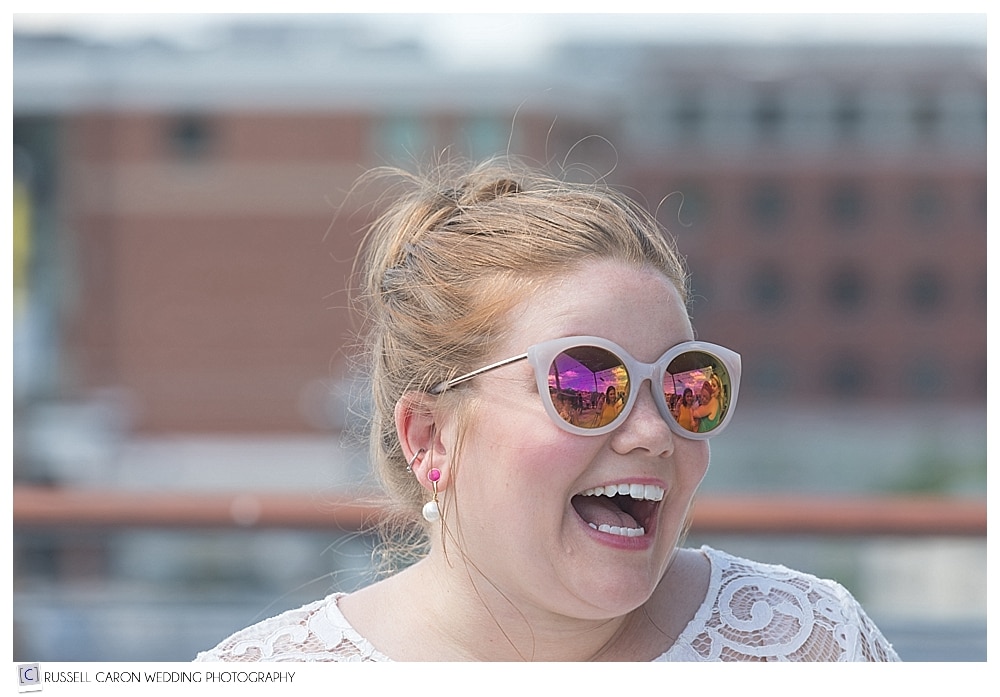 laughing woman wearing sunglasses 
