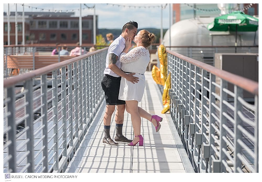 man and woman kissing on the rooftop at Bayside Bowl, Portland, Maine