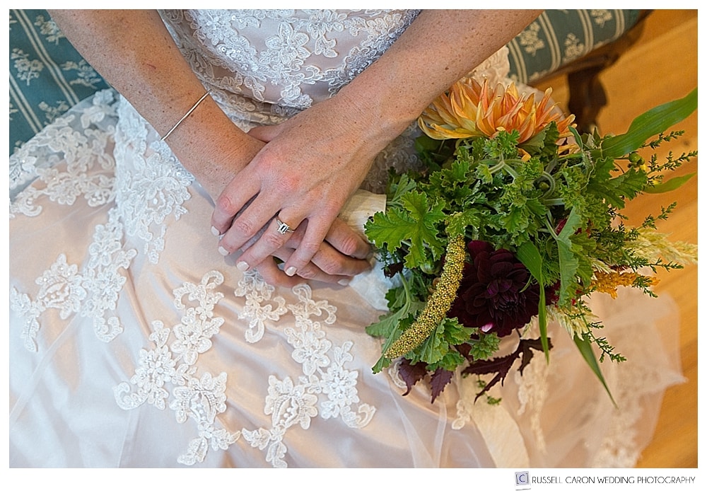 bride sitting with bridal bouquet in her lap
