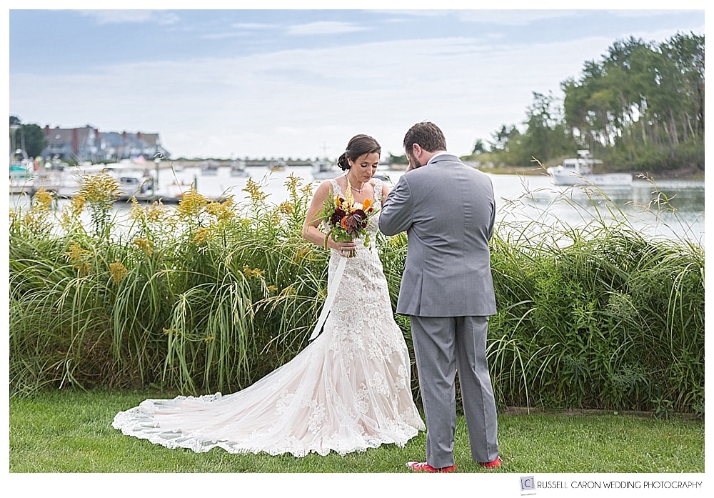 bride and groom during first look on the banks of the Kennebunk River in Kennebunkport, maine