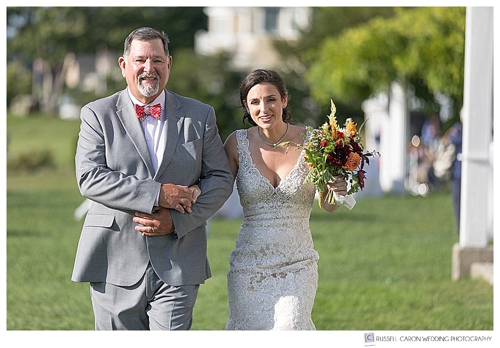 bride and her father walking towards the outdoor ceremony site at the Nonantum, Kennebunkport, Maine