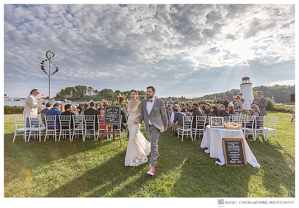 bride and groom during recessional at the Nonantum Resort, with dramatic cloudy skies