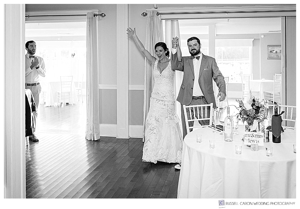 black and white photo of bride and groom entering the Nonantum Resort ballroom