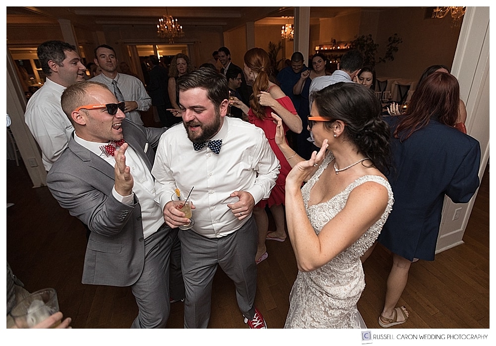 bride and groom dancing with guest