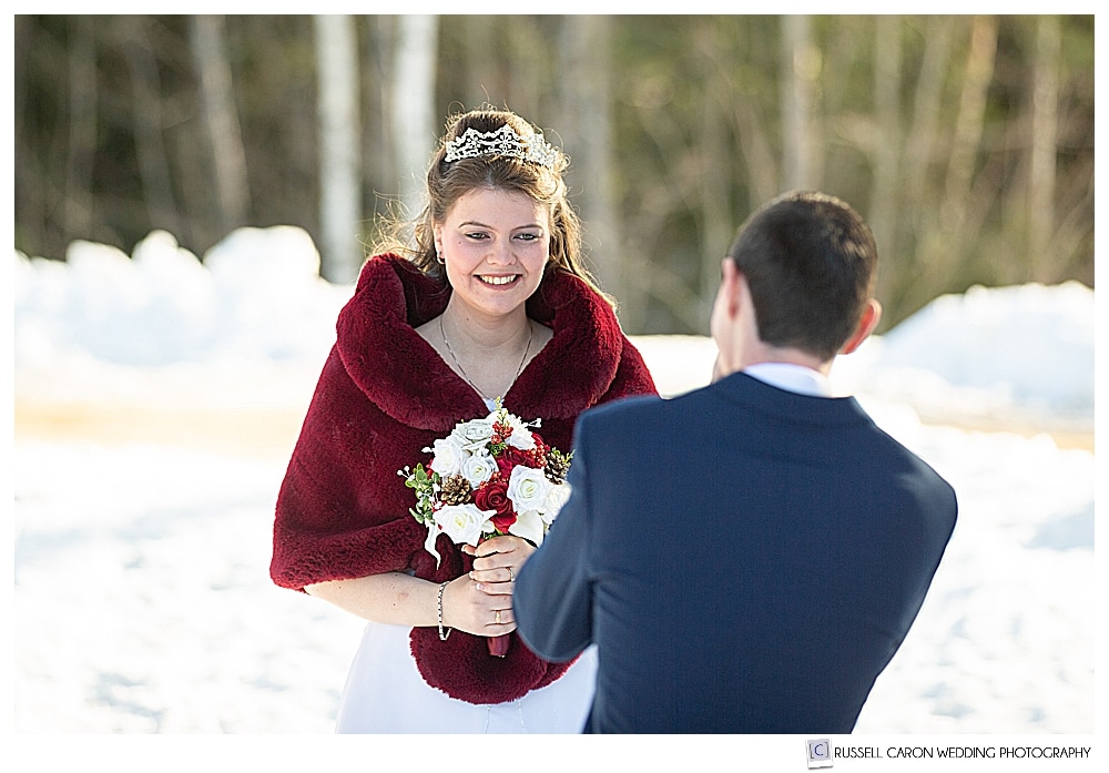 bride smiling as she sees groom during wedding day first look