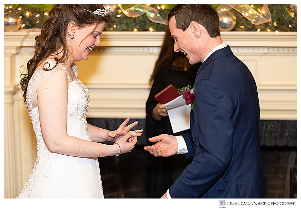 bride fixes wedding ring on her finger during her Bethel Maine wedding ceremony