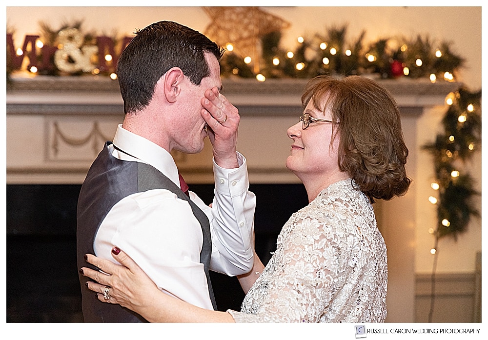groom wipes his eyes during mother son dance