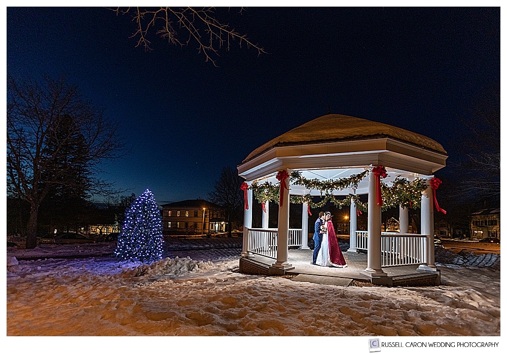 bride and groom kissing in the Bethel Inn gazebo during a winter Maine wedding