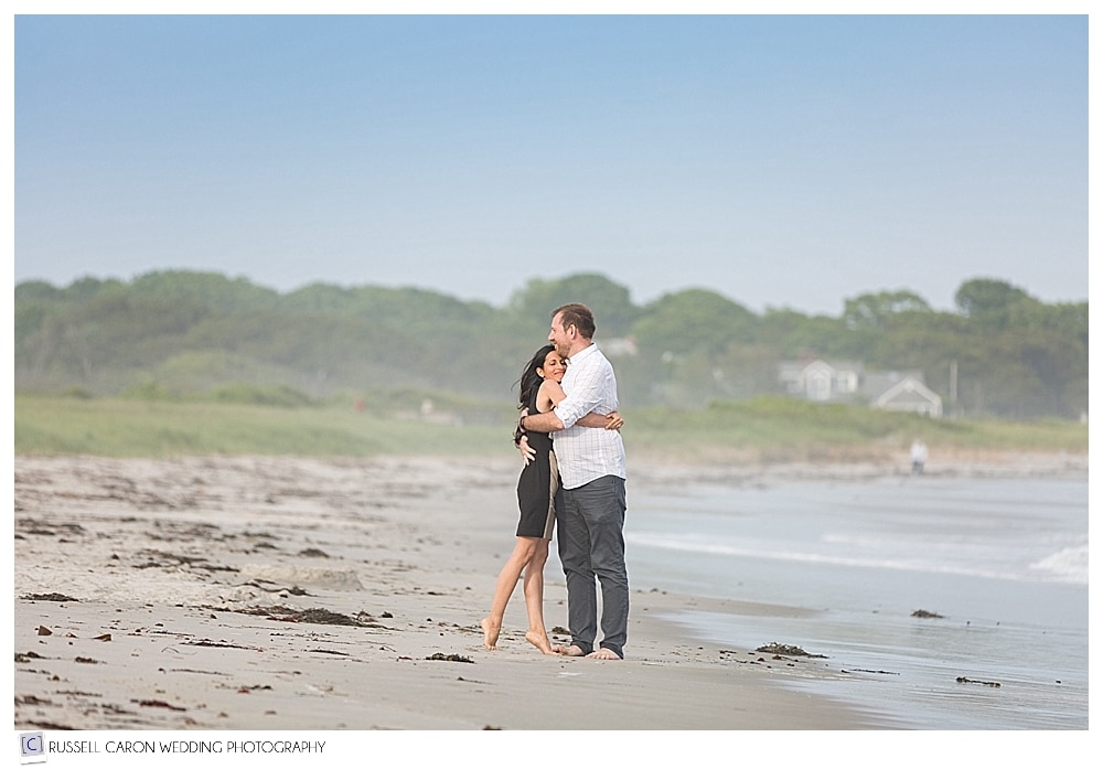 Man and woman hugging during Biddeford Pool Maine engagement session on the beach