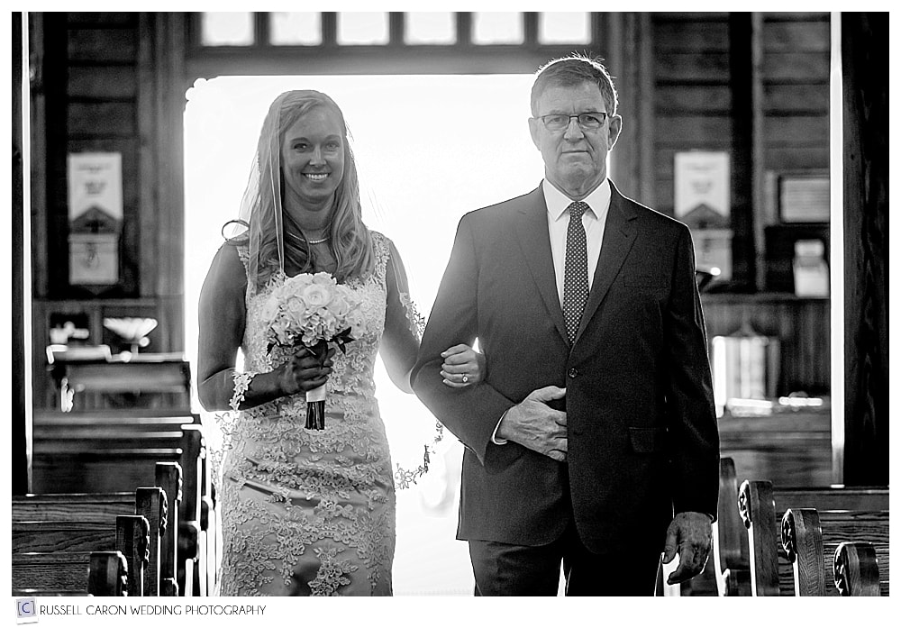 bride and her father walking down the isle at Our lady Queen of Peace