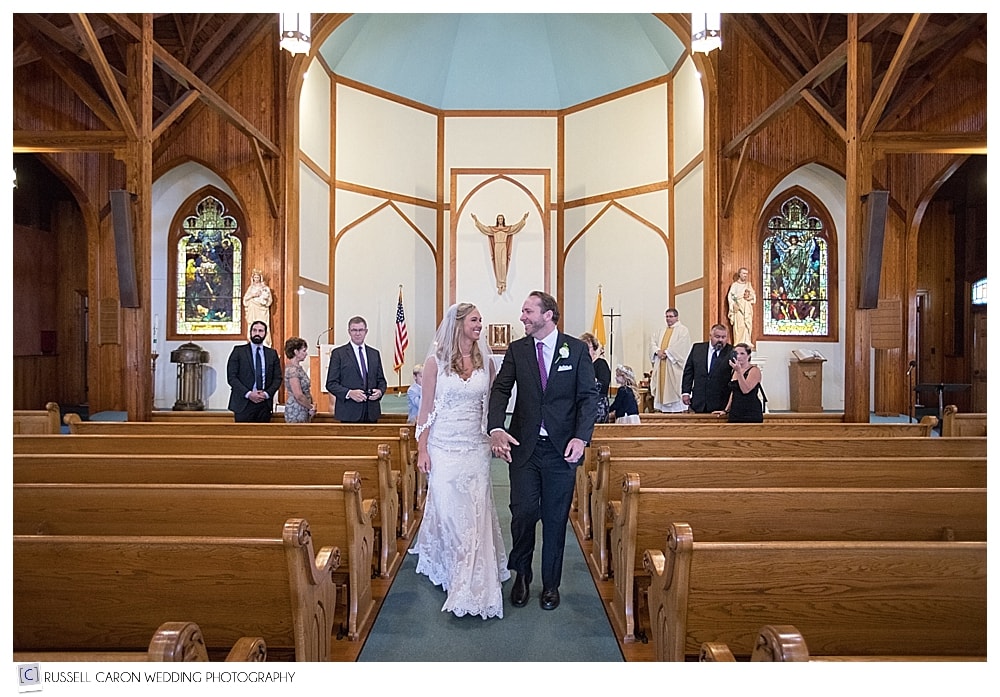 bride and groom during recessional at Our Lady Queen of Peace Church Boothbay Harbor Maine