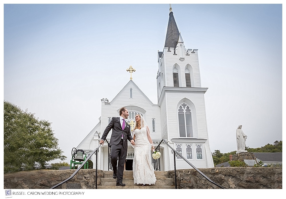 bride and groom on the steps at Our Lady Queen of Peace Church, Boothbay Harbor Maine