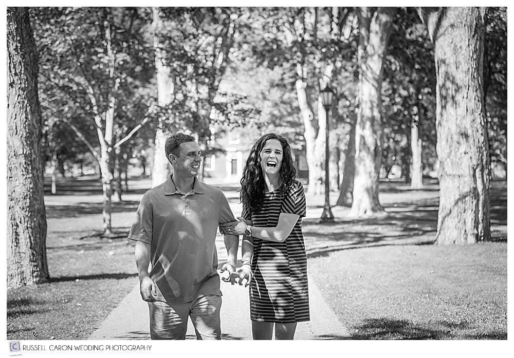 couple walking and laughing during Bowdoin College engagement session