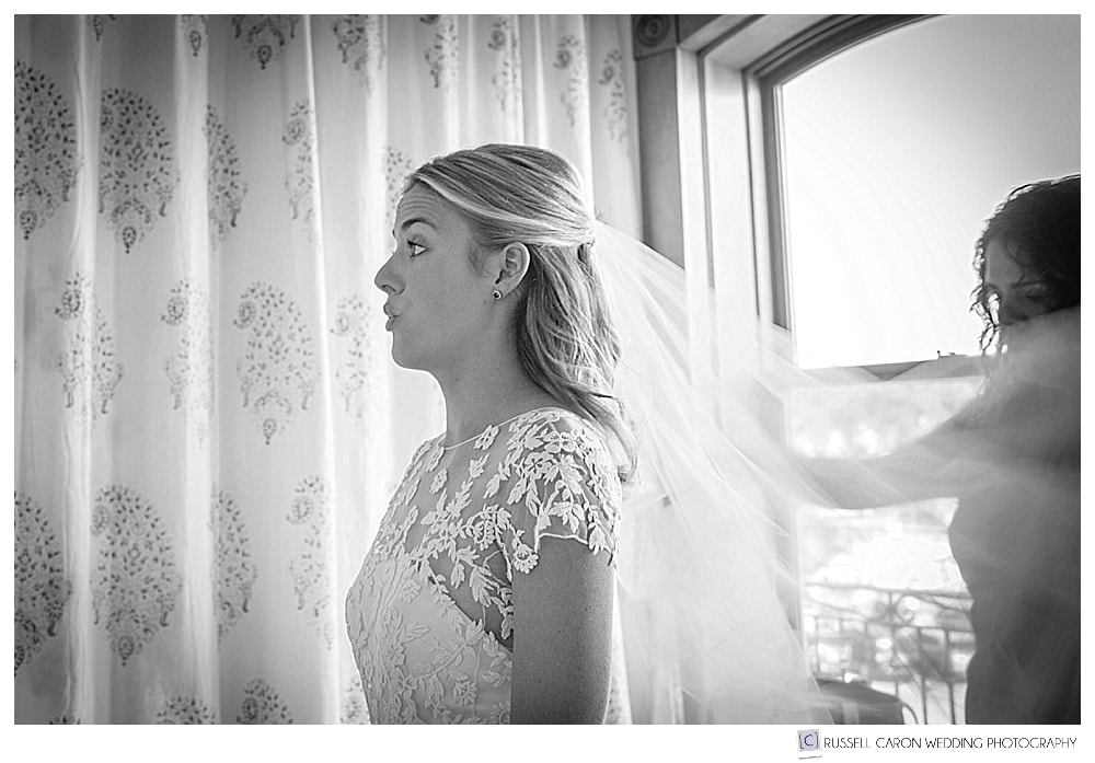 black and white photo of bride getting her veil put in
