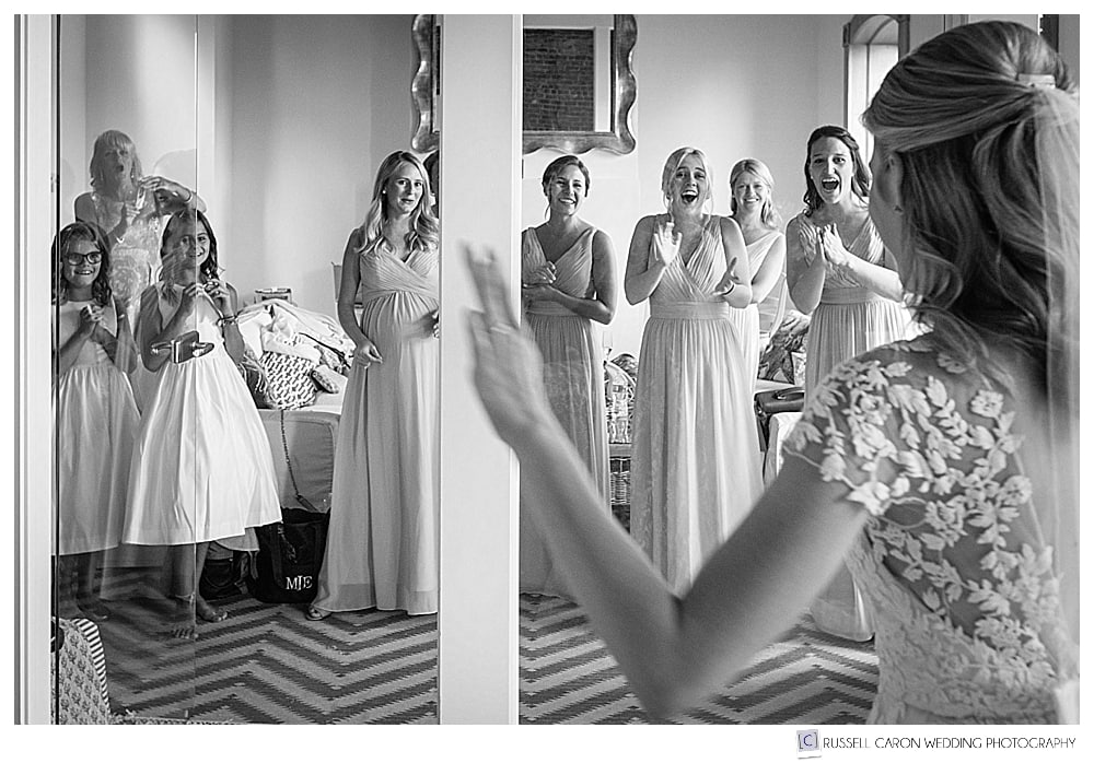 black and white photo of bridal reveal to bridesmaids 