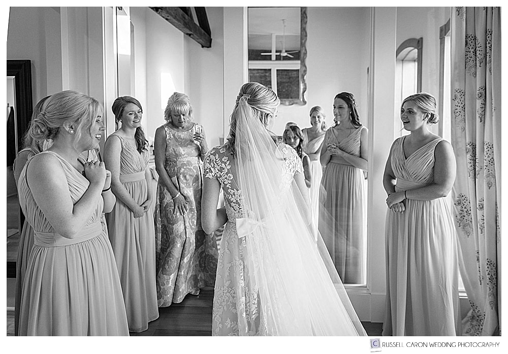 black and white photo of bridesmaids seeing bride for the first time