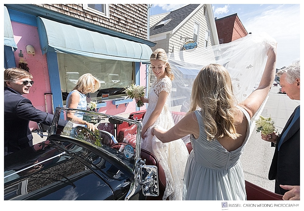 bride getting into antique car in Camden, Maine