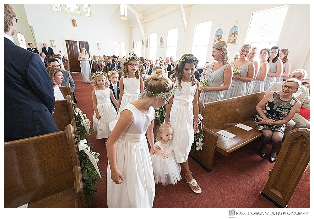 flower girls and ring bearer walking down the aisle at Our Lady of Good Hope Church in Camden, Maine