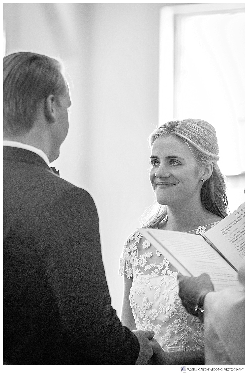 black and white photo of bride looking at groom during the vows