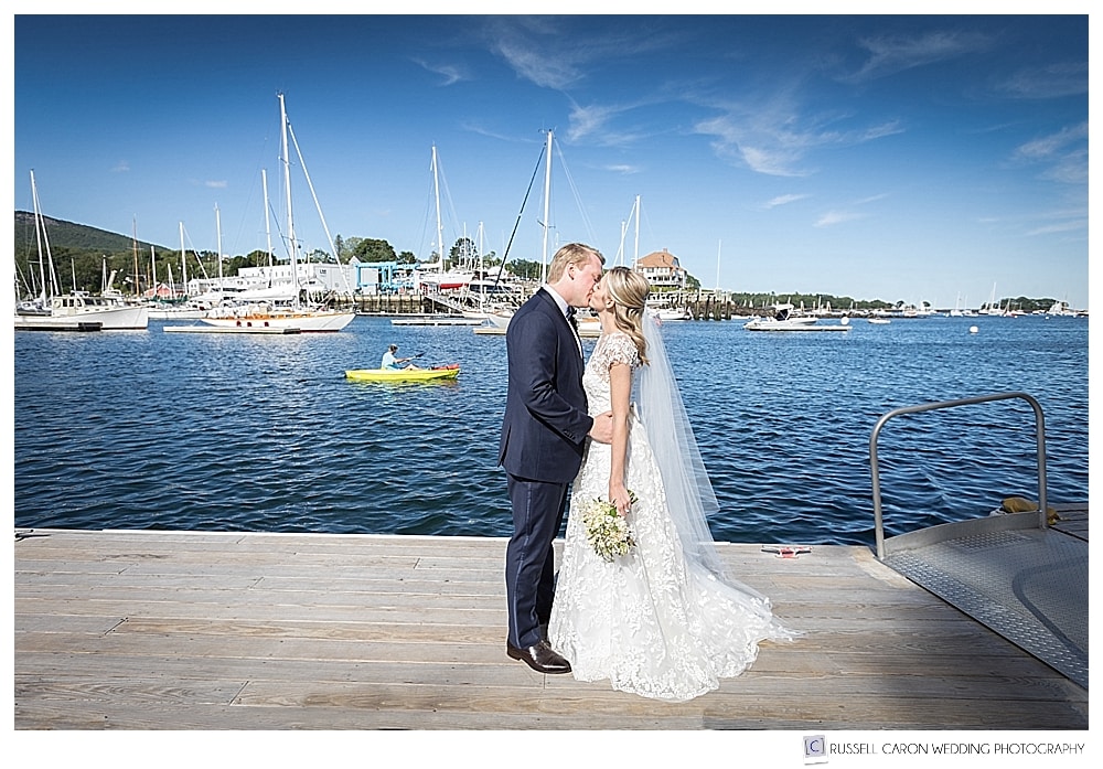 bride and groom kissing on a dock in Camden Harbor, Camden, Maine 
