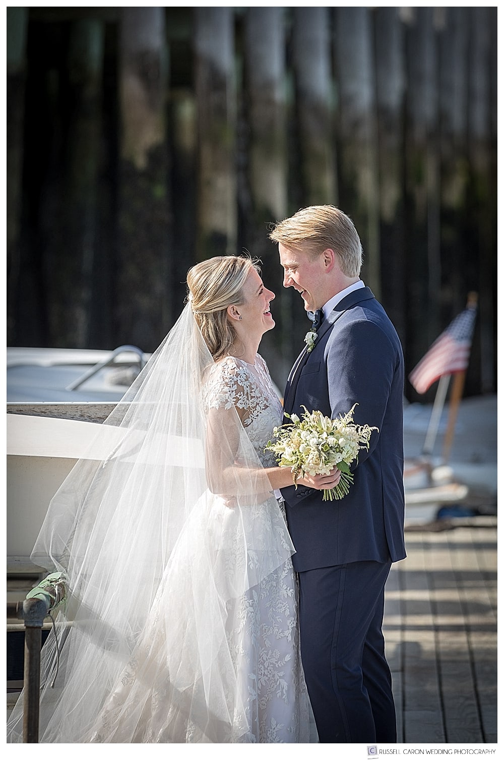 bride and groom standing together on the dock in Camden Harbor, Camden, Maine