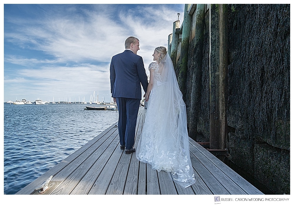 bride and groom walking down a dock in Camden, Maine
