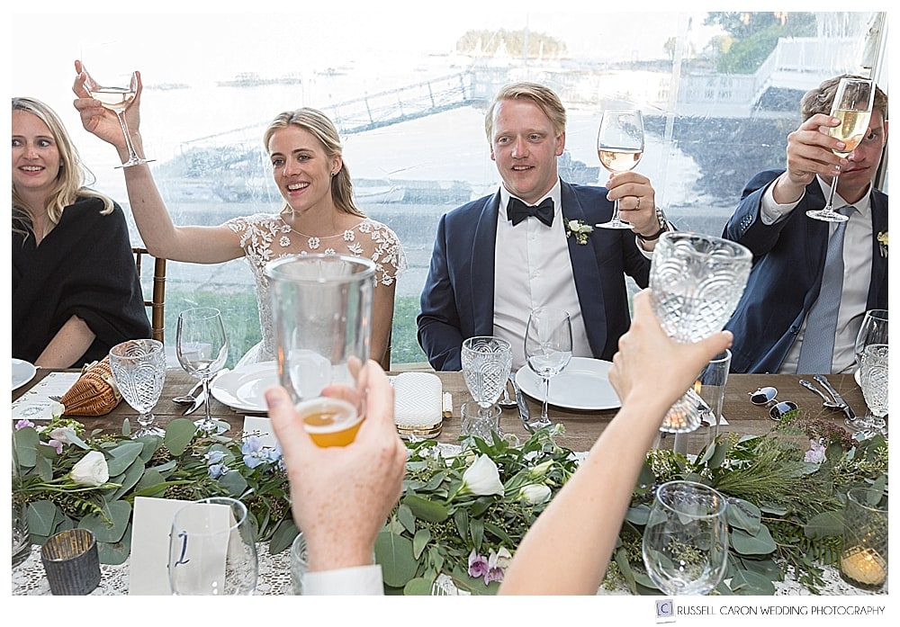 bride and groom toasting guests