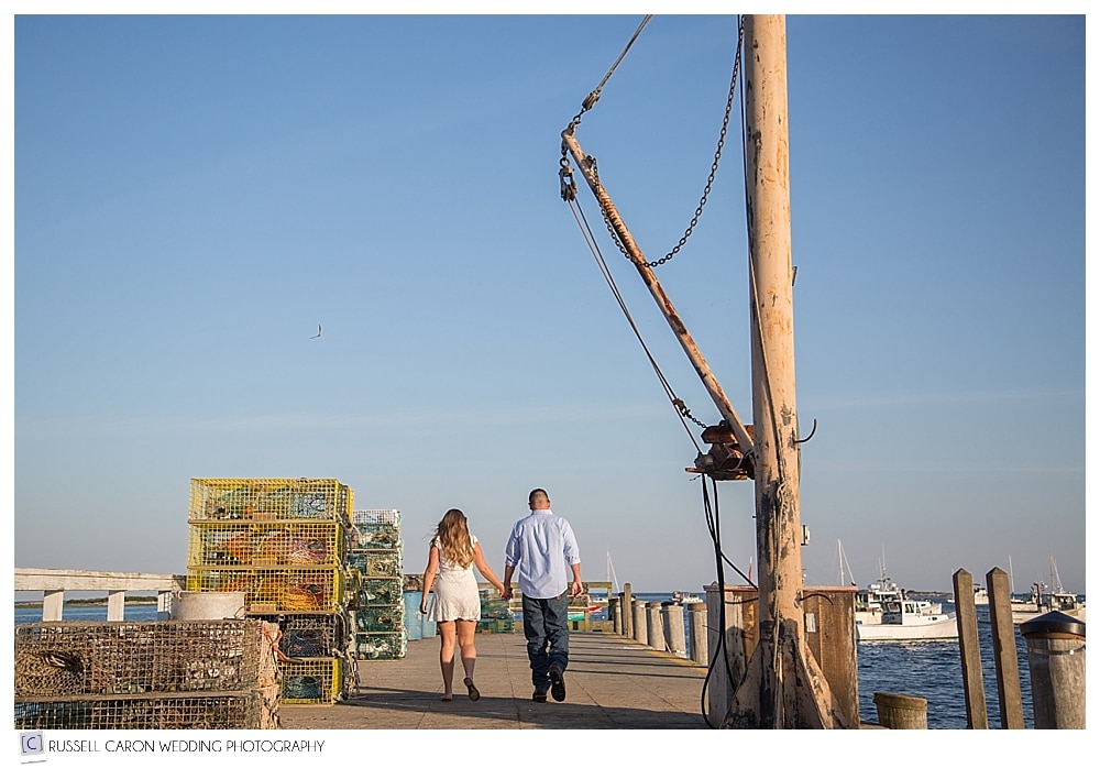 couple walking hand in hand during Cape Porpoise engagement session