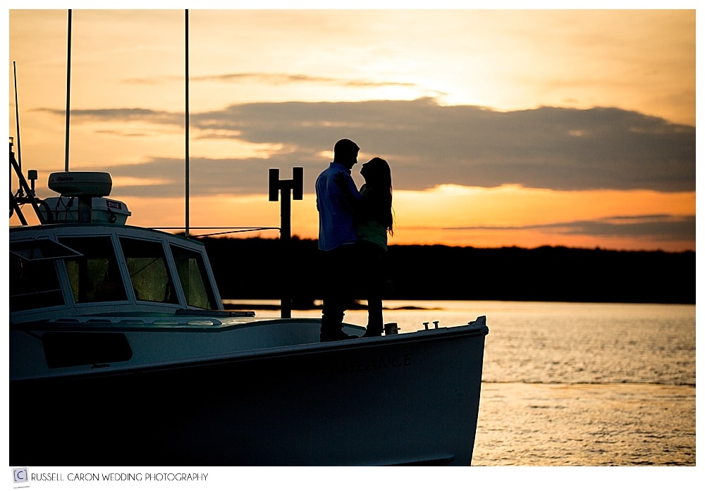 couple-on-bow-of-lobster-during-sunset