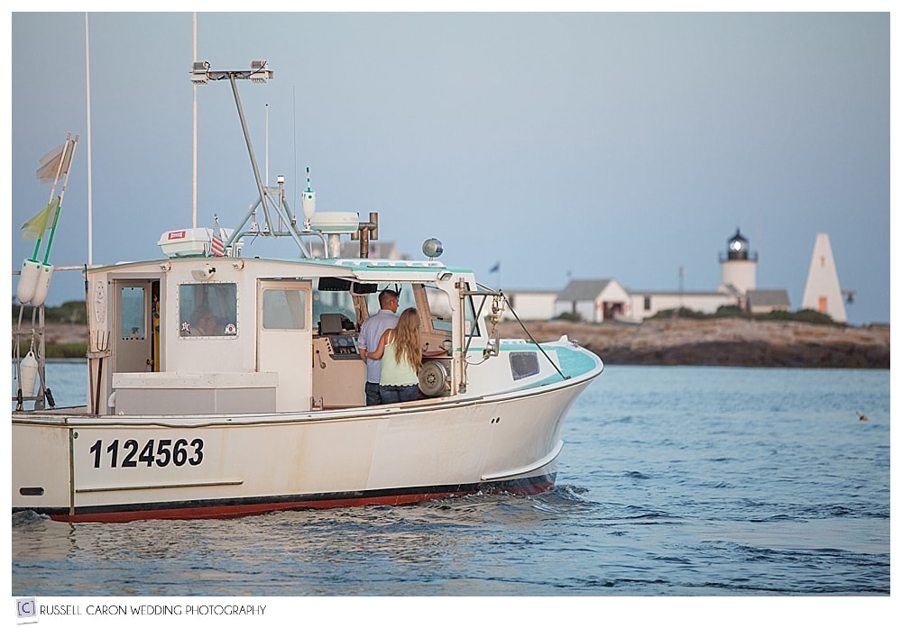 couple-rinding-in-lobster-boat-during-engagement-session-in-kennebunkport