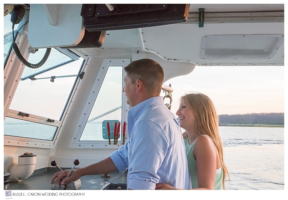 couple-driving-lobster-boat-during-cape-porpoise-engagement-session