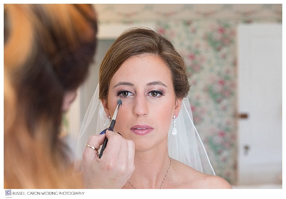 bride having makeup applied