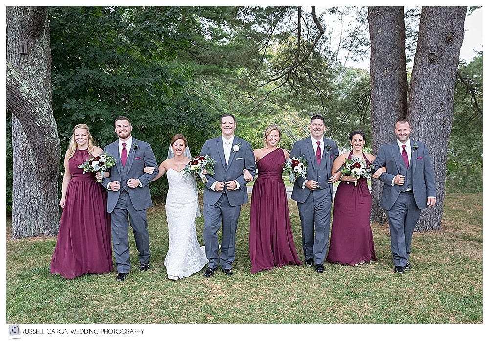 bridal party walking arm in arm