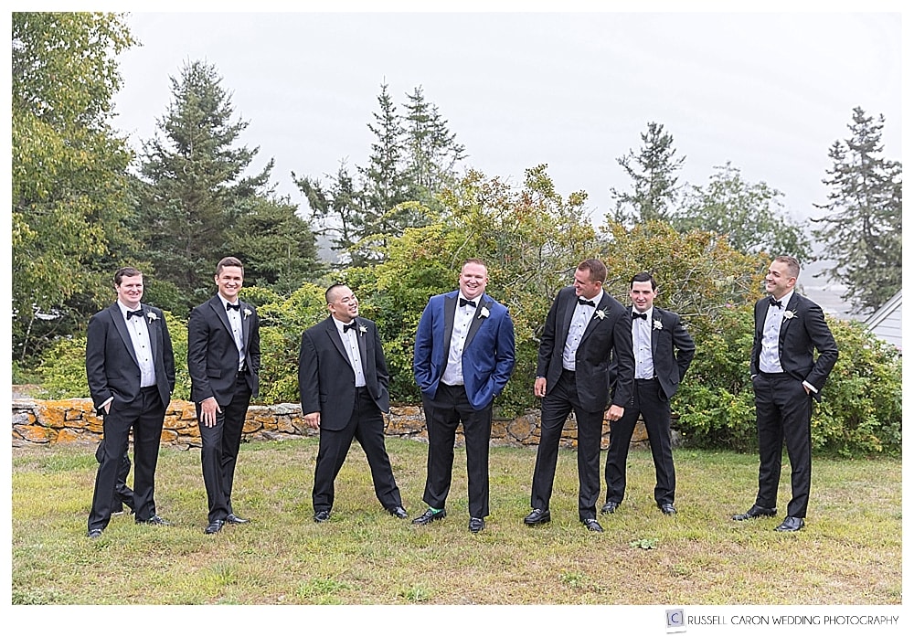 groom and groomsmen laughing together