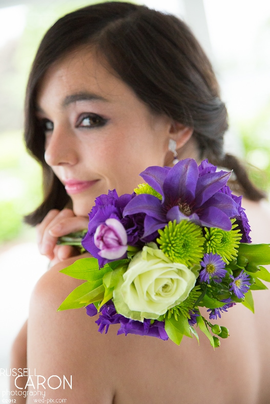 Bridesmaid with bright green and purple bouquet