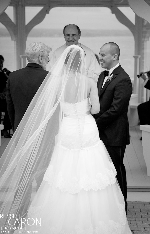 Father of the bride hands the bride over to her groom at a Maine wedding