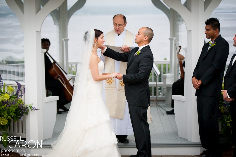 Grrom wipes away a tear from the bride's face