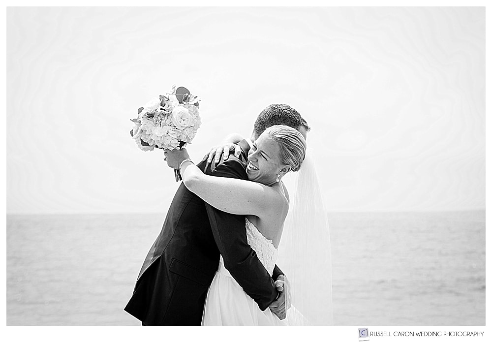 bride and groom hug during wedding day first look on colony beach, kennebunkport maine