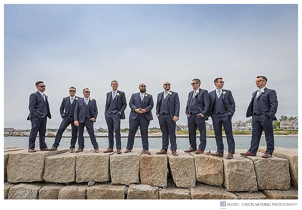 groomsmen standing on the kennebunkport maine breakwater
